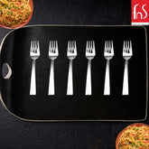 Six stainless steel dessert forks arranged on black serving tray with pasta dishes